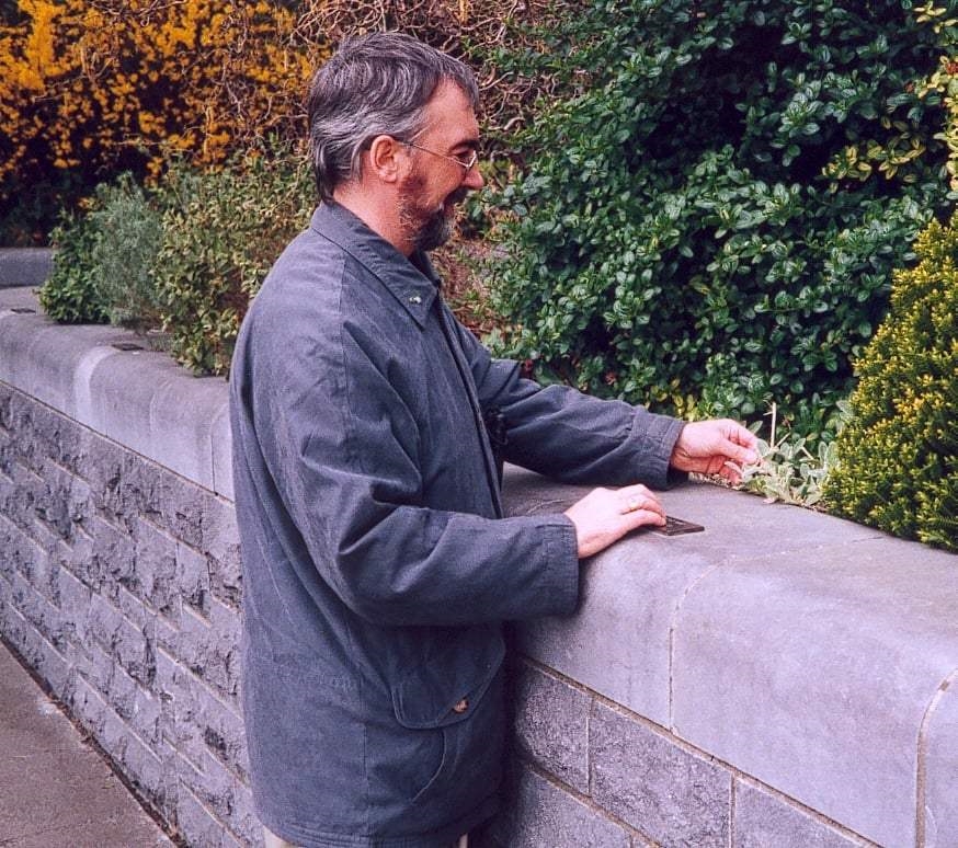 A visitor reading the Braille signage in the garden for the blind in St Stephen's Green, Dublin City Centre